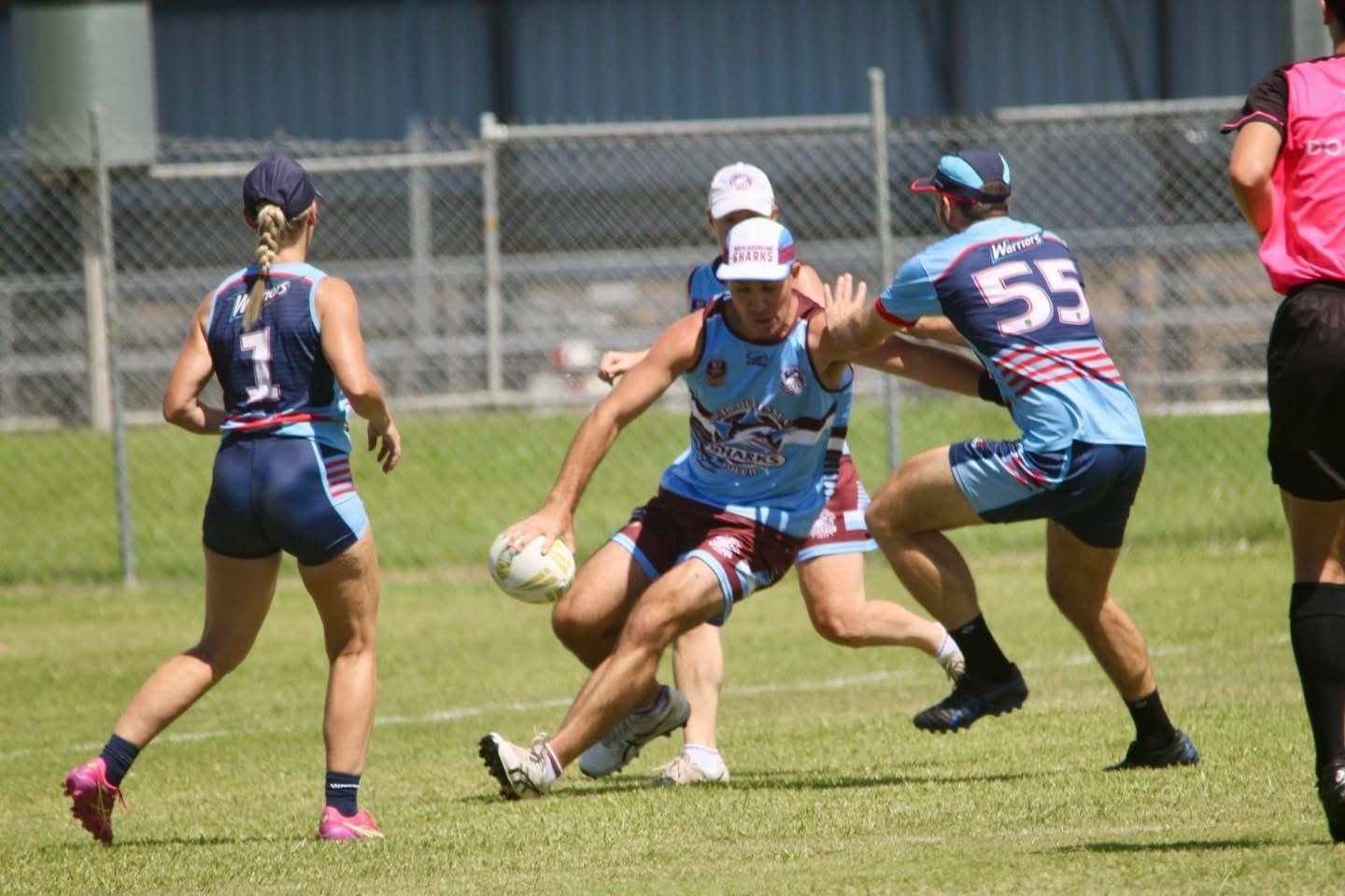 Sharks touch football player runs with the ball while being tagged by a Warriors player.